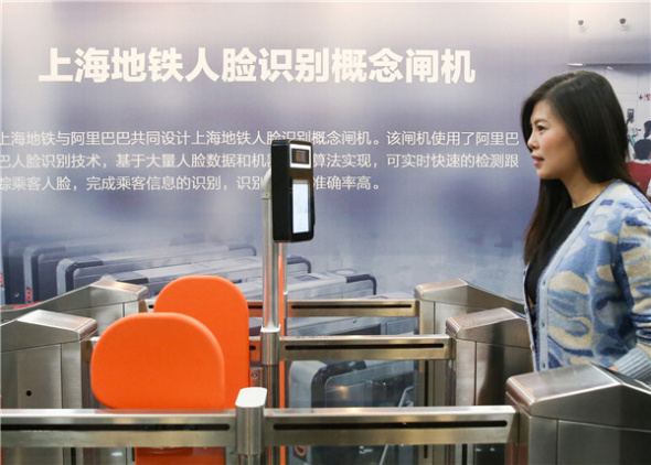 A woman checks in a subway station through facial recognition in Shanghai