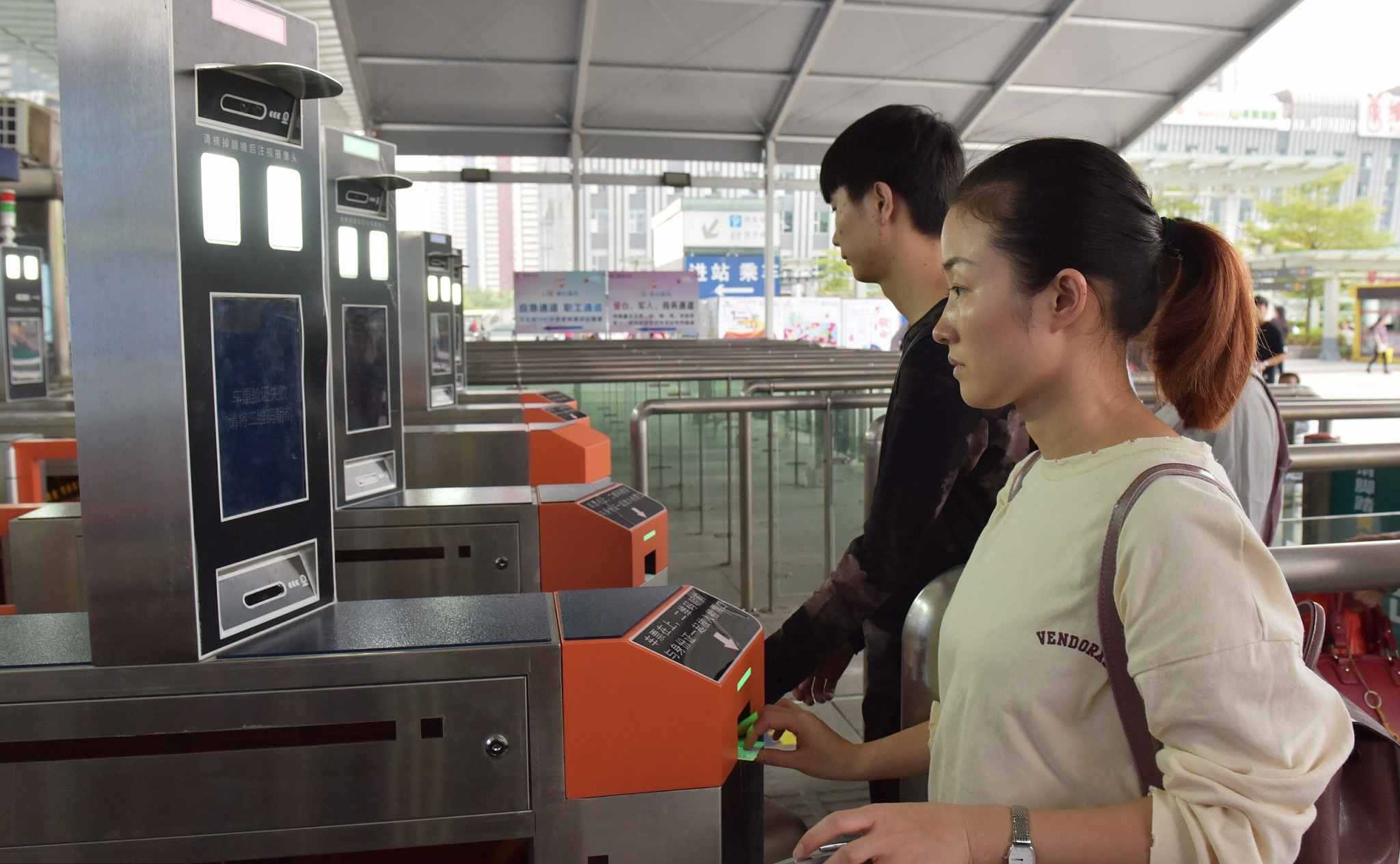 Passengers are identified by facial recognition system by swiping ID cards at Shenzhen North Railway Station