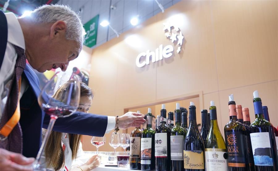 A man looks at wine from Chile at the first China International Import Expo in Shanghai