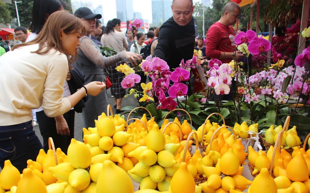 People buy flowers at a flower market in Guangzhou