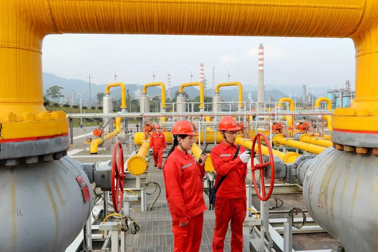 Workers inspect pipelines at a natural gas facility run by Sinopec in Dazhou Sichuan province China