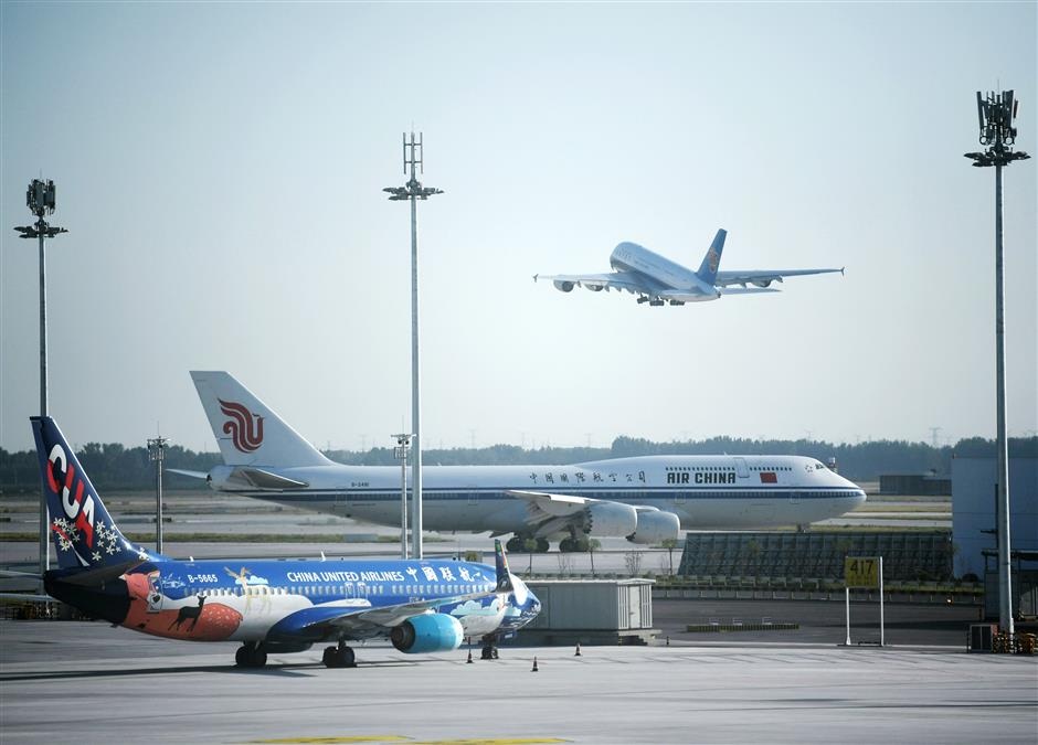 The A380 Superjumbo with China Southern Airlines takes off from the Daxing airport while the Boeing 747 with Air China and a Boeing 737 with China United Airlines are about to take off