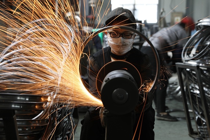 A worker makes a bicycle rim on Sept. 2 at a sports equipment factory in Hangzhou