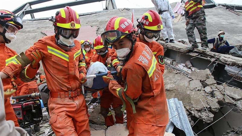A man is rescued from the rubble of a collapsed hotel in Quanzhou where 71 people were held under observation for coronavirus