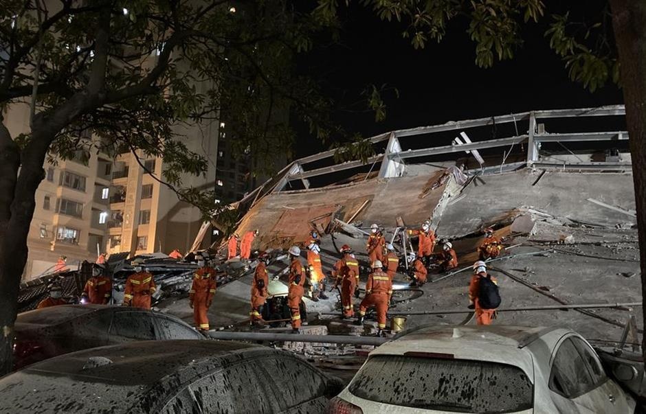 Rescuers work at the accident site of a hotel in Quanzhou Fujian Province 3