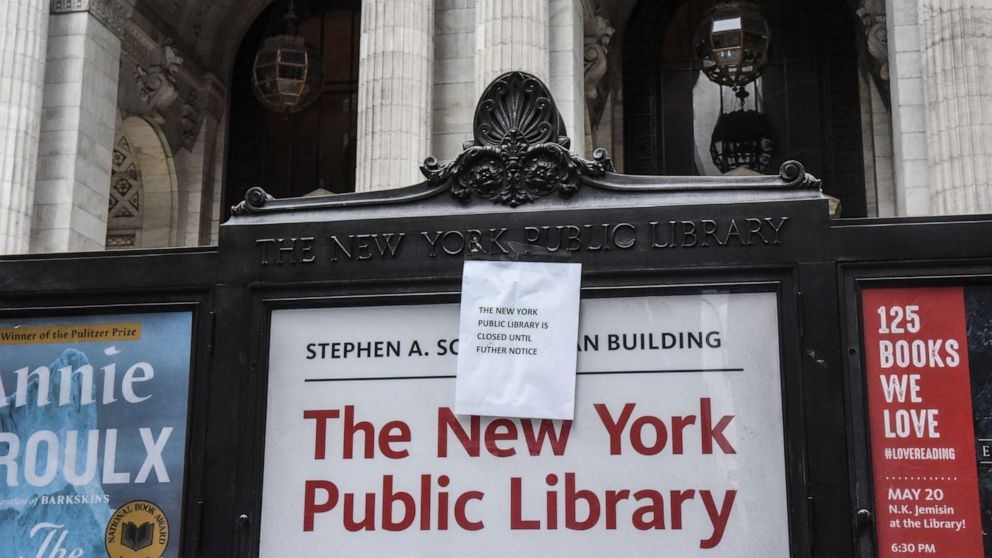 A sign announces the closure of the New York Public Library main branch on Fifth Avenue