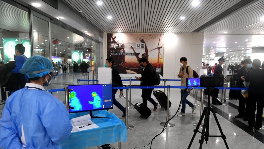 Passengers have their temperature checked at the Fuzhou Changle International Airport in Fuzhou
