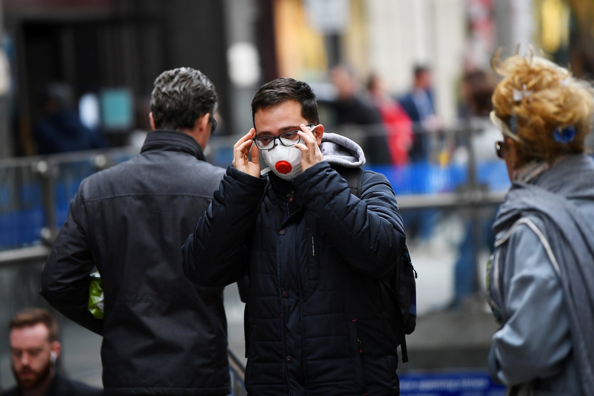 A man wears a mask as he walks through Knightsbridge as the number of coronavirus cases grow around the world in central London Britain March 14 2020