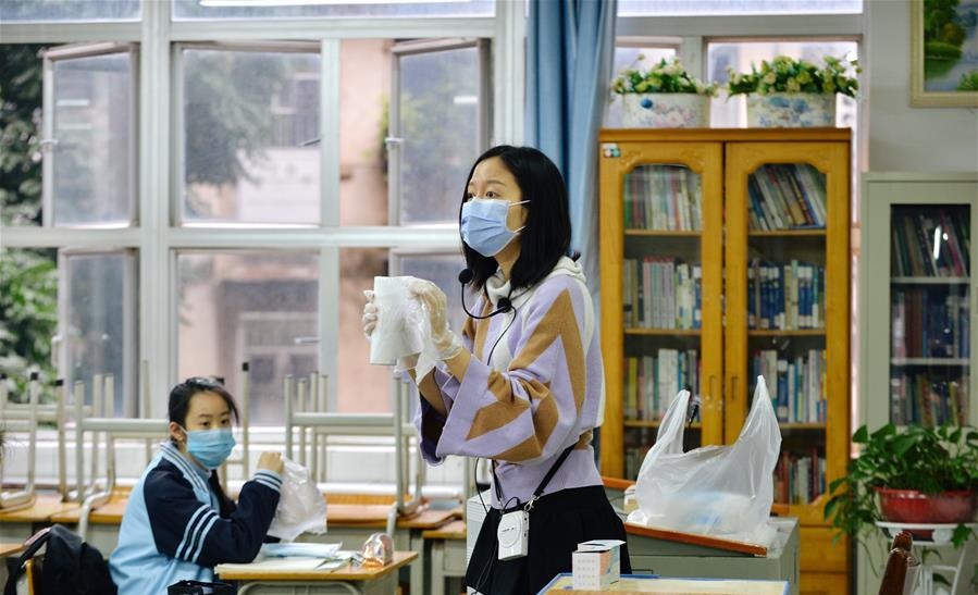 A teacher gives a lesson on the coronavirus epidemic prevention
