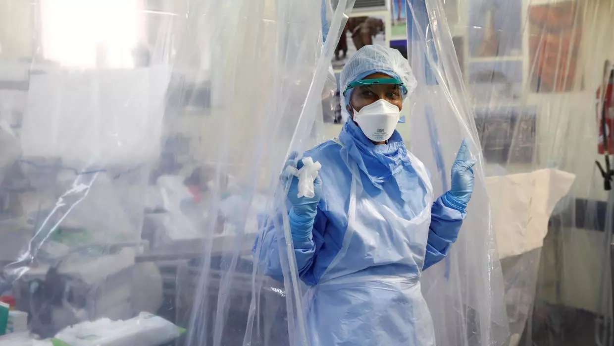 Medical staff wearing protective suits and face masks treat a patient suffering from coronavirus disease COVID 19 in an intensive care unit
