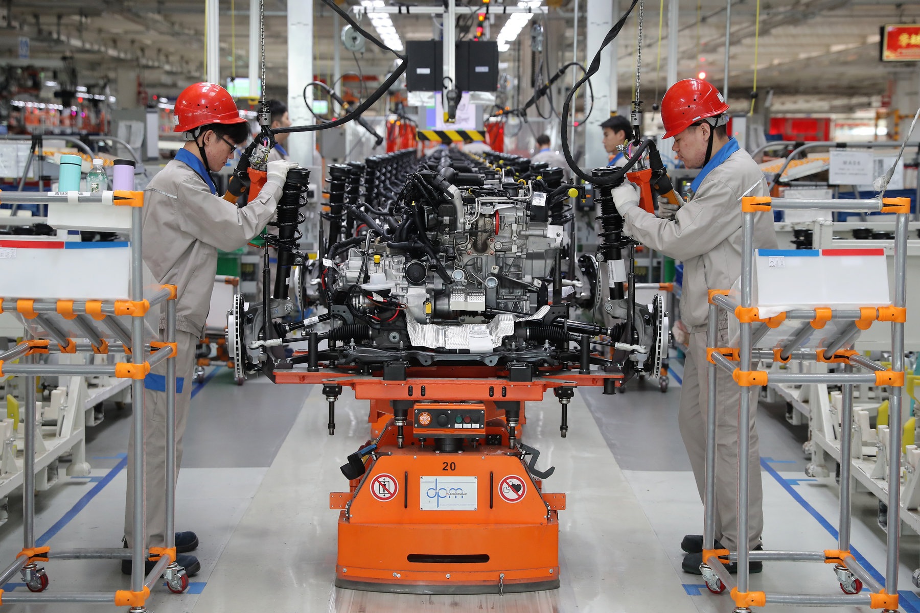 Employees work on the assembly line of Audi Q3 at a whole vehicle manufacturing base of the Sino German joint venture FAW Volkswagen Automotive Co Ltd on Dec. 5 2019 in Tianjin