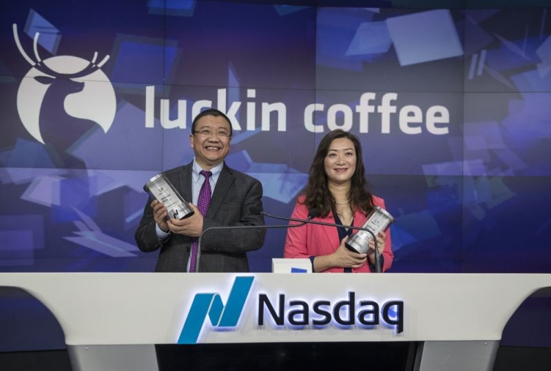 chairman and founder of Luckin Coffee Inc. stand for photographs before ringing the opening bell during the companys initial public offering IPO at the Nasdaq MarketSite in New York U.S