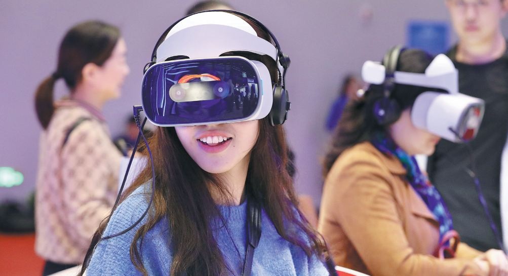 Visitors to the Light of the Internet Expo part of the ongoing World Internet Conference try a wearable musical device using virtual reality technology