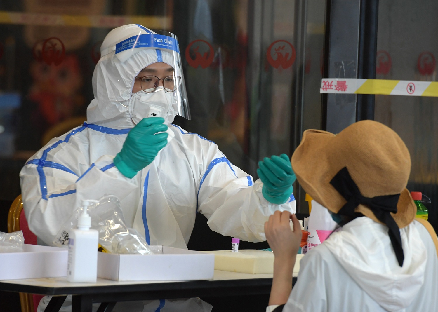 A woman is tested for the coronavirus in the Jiangsu Province of Beijing