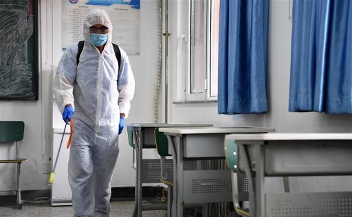 A staff member disinfects a classroom at a middle school in Tianjin