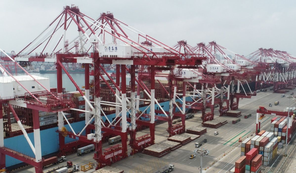 Cargo is loaded onto ships at Qingdao port in Shandong province