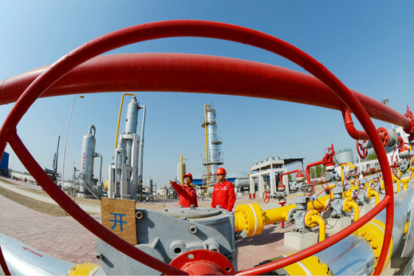 workers conduct a safety inspection on a natural gas transmission facility in April 2014 in Henan province