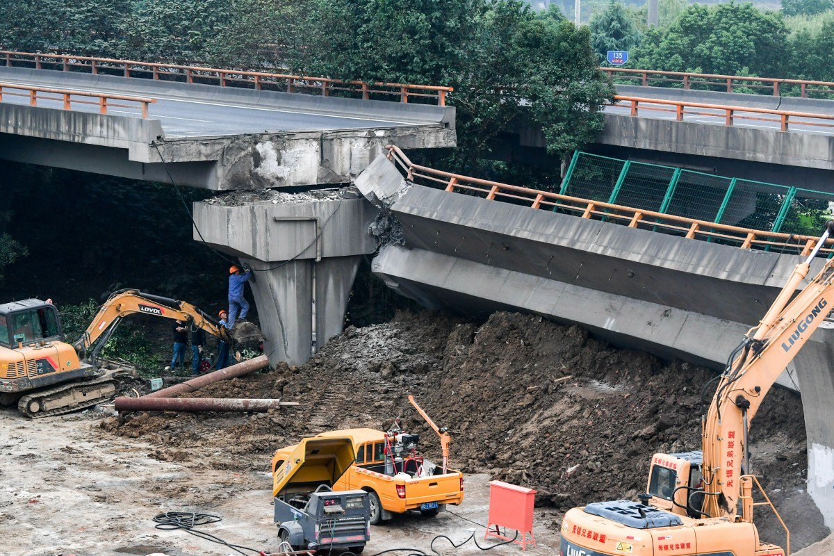 Rescuers work to remove rubble at the site of a flyover collapse in Wuxi Jiangsu province on Friday