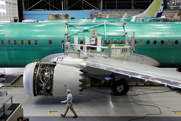 030 A worker walks past s Boeing 737 MAX 9 under construction at its production facility in Renton Washington. 