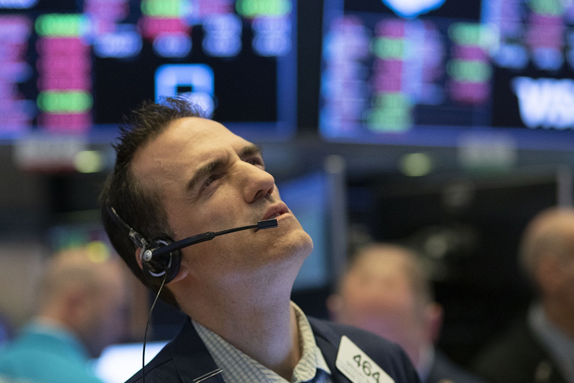 A stock trader works at the New York Stock Exchange on Wednesday