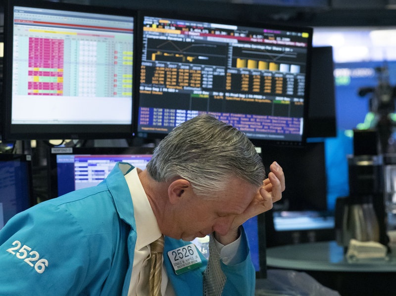 A trader reacts after automatic circuit breakers kicked in and trading was halted temporarily Wednesday at the New York Stock Exchange